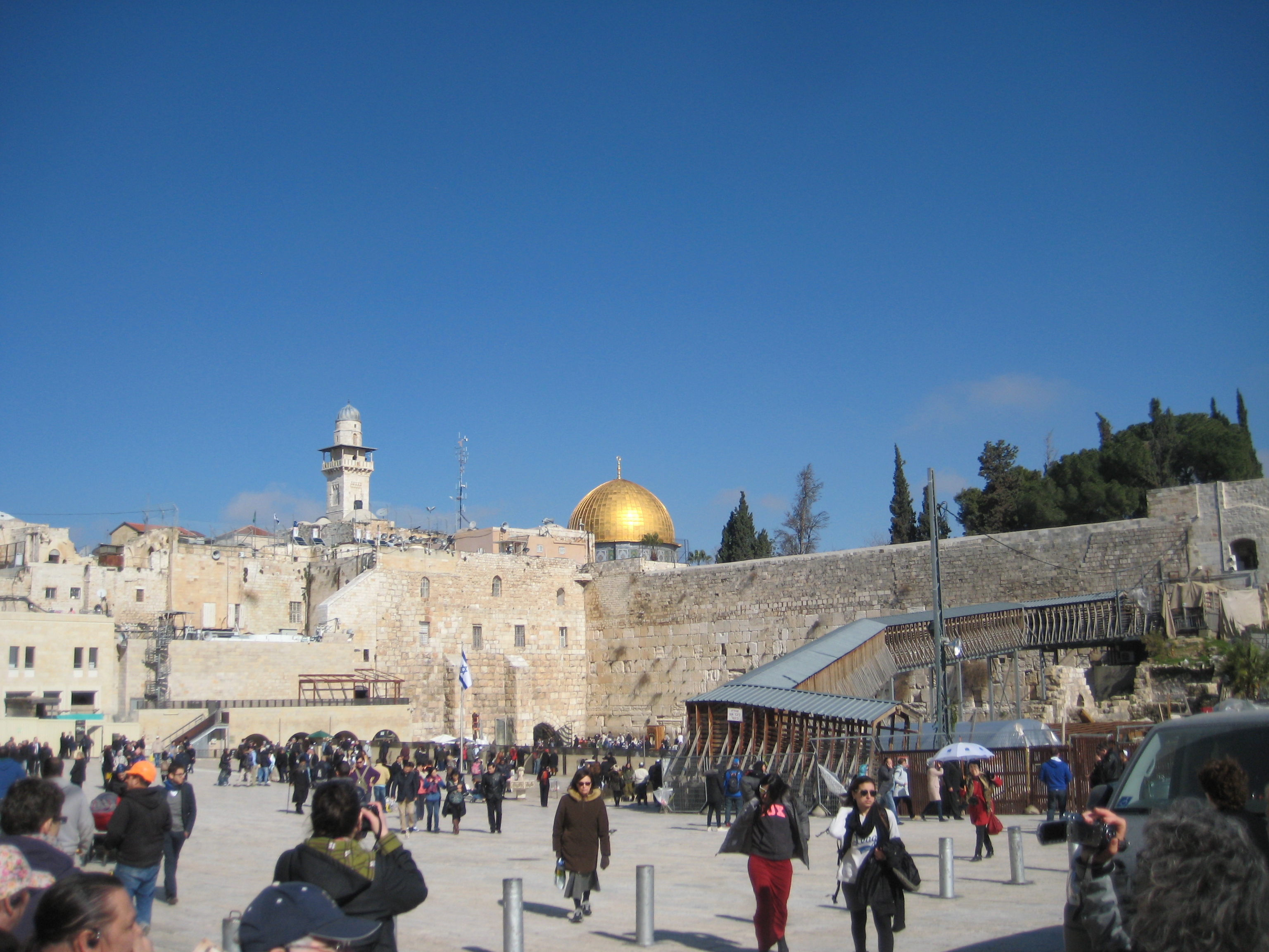 The Western Wall, right after we walked through a security checkpoint. The Muslim mosque, the Dome on the Rock, is the gold dome on the horizon.